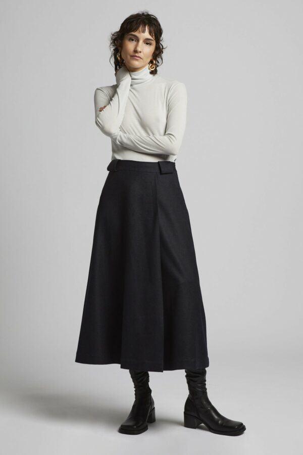 Fashion model wears MIOMARTHA high waist flared skirt in blue grey wool with slim fit tencel shirt - SKU 2027HR001